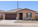 Charming single-story home with a two-car garage, stone accents, neutral paint, and a well-maintained front yard at 37399 W San Sisto Ave, Maricopa, AZ 85138