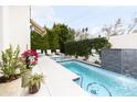 Relaxing backyard pool and spa area with waterfall feature and lounge chairs at 3927 E Sheila Ln, Phoenix, AZ 85018