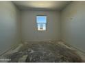 Bright bedroom with a window offering natural light and blank canvas flooring at 4521 S 95Th Dr, Tolleson, AZ 85353