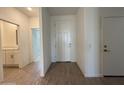 Inviting entryway featuring wood-look flooring and views of the bathroom and closet at 4521 S 95Th Dr, Tolleson, AZ 85353