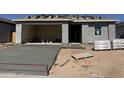 A newly built single-Gathering home with an attached garage and a freshly poured concrete driveway at 4521 S 95Th Dr, Tolleson, AZ 85353