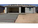New construction single-story home featuring an open garage, stucco exterior, and concrete driveway at 4521 S 95Th Dr, Tolleson, AZ 85353