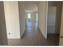 A long hallway with wood-look tile floors leads to other rooms in the home at 4521 S 95Th Dr, Tolleson, AZ 85353