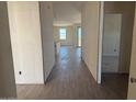 A bright hallway featuring hard flooring leads to multiple rooms with window views at 4521 S 95Th Dr, Tolleson, AZ 85353