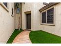 Inviting entryway with artificial turf, a stone walkway, and a stylish front door at 461 W Flamingo Dr, Chandler, AZ 85286