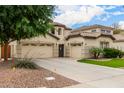 Beautiful home boasts a three-car garage, landscaped front yard, and desert surroundings at 461 W Flamingo Dr, Chandler, AZ 85286