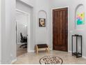 Welcoming foyer showcasing a decorative tile floor and modern decor with a wood door at 461 W Flamingo Dr, Chandler, AZ 85286