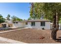 A single-story home with a neatly landscaped yard and modern curb appeal, framed by mature trees and clear skies at 510 W 14Th St, Tempe, AZ 85281