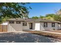 Well-maintained single-story home with clean lines, contrasted by lush trees, creating a serene outdoor setting at 510 W 14Th St, Tempe, AZ 85281