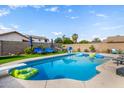 Inviting pool area with lounge chairs, umbrellas, and a diving board, perfect for summer relaxation and entertaining at 528 E Kyle Ct, Gilbert, AZ 85296