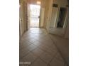 Inviting entryway featuring tile floors, mirrored wall, and secure front door at 6230 S Championship Dr, Chandler, AZ 85249