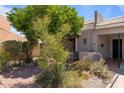 View of house exterior surrounded by desert landscaping, pavers, and a thriving citrus tree at 7611 E Pasadena Ave, Scottsdale, AZ 85250