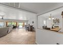 Open-concept living space with tile floors, a bar area, and backyard access at 7611 E Pasadena Ave, Scottsdale, AZ 85250