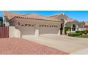 Spacious three-car garage with decorative doors and ample driveway space at 7648 W Mauna Loa Ln, Peoria, AZ 85381