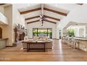 Bright living room with exposed wooden beams, hardwood floors, and a fireplace at 8329 N Ridgeview Dr, Paradise Valley, AZ 85253