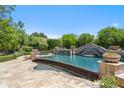 Stunning pool featuring a waterfall feature surrounded by lush landscaping, creating a backyard oasis at 8329 N Ridgeview Dr, Paradise Valley, AZ 85253