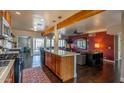 Open-concept kitchen with modern appliances, island seating, and easy access to the living area at 836 W Mitchell Dr, Phoenix, AZ 85013