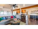 Cozy living room featuring hardwood floors, exposed beams, and seamless flow to the kitchen at 836 W Mitchell Dr, Phoenix, AZ 85013
