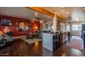 Spacious living room with a mirror feature and hardwood flooring that connects to the kitchen at 836 W Mitchell Dr, Phoenix, AZ 85013