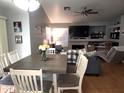 Spacious dining and living room with vaulted ceilings, a cozy fireplace, and plenty of natural light at 9252 W Carol Ave, Peoria, AZ 85345