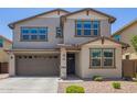 Two-story home with a brown two-car garage, desert landscaping, and neutral paint scheme at 1081 E Armstrong Way, Chandler, AZ 85286