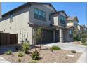 Side view of the charming two-story home with beautiful landscaping and an attached garage at 1081 E Armstrong Way, Chandler, AZ 85286