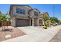 Two-story home with a brown two-car garage, desert landscaping, and neutral paint scheme at 1081 E Armstrong Way, Chandler, AZ 85286