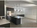 Bright, open kitchen with large island, ample cabinets, and modern pendant lighting at 1081 E Armstrong Way, Chandler, AZ 85286