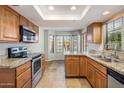 Well-lit kitchen featuring stainless steel appliances, granite countertops, and wood cabinetry at 11049 N 111Th Way, Scottsdale, AZ 85259