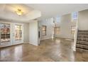 Bright living room with soaring ceilings, tiled floors, fireplace, and French doors leading to the outdoors at 11049 N 111Th Way, Scottsdale, AZ 85259