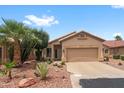 Charming single-story home with desert landscaping and a two-car garage at 11553 W Cottontail Ct, Surprise, AZ 85378