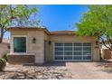 Single-story home with a glass paneled garage door and desert landscaping at 12083 W Peak View Rd, Peoria, AZ 85383