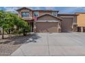 Charming two-story home featuring a three-car garage and low-maintenance landscaping at 12238 W Patrick Ct, Sun City, AZ 85373
