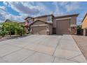 Inviting two-story home with a three-car garage and a spacious driveway at 12238 W Patrick Ct, Sun City, AZ 85373