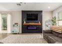 Comfortable living room featuring a modern electric fireplace and a cozy seating area at 13380 N 148Th Ave, Surprise, AZ 85379