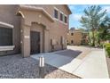 Inviting townhome entrance with desert landscaping and a covered entryway at 15240 N 142Nd Ave # 2171, Surprise, AZ 85379