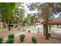 Outdoor community pool with multiple chairs, tables and landscaped surroundings offer a refreshing experience at 15252 N 100Th St # 1172, Scottsdale, AZ 85260