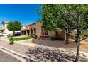 Charming home exterior showcasing well-maintained landscaping and picturesque curb appeal at 15416 W Valentine St, Surprise, AZ 85379