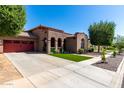 Exterior shot featuring a well-kept lawn, beautiful landscaping and charming architecture at 15416 W Valentine St, Surprise, AZ 85379