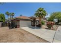 Well-maintained home with a desert landscaped yard, long driveway and a two car garage at 15848 W Calavar Rd, Surprise, AZ 85379