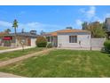 Charming single-story home with a brick pathway, lush lawn, and vibrant landscaping at 1618 W Vernon Ave, Phoenix, AZ 85007