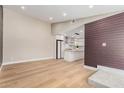 Open-concept living space with hardwood floors and a view of the modern kitchen at 1624 E Campbell Ave # 51, Phoenix, AZ 85016