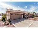 Inviting single-Gathering home featuring a two-car garage, desert landscaping, and a welcoming entryway under a sunny sky at 16654 N 19Th Pl, Phoenix, AZ 85022