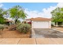 Lovely single-story home with desert landscaping and a two-car garage, offering curb appeal at 17128 N Princess Pl, Surprise, AZ 85374