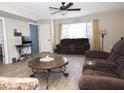 Cozy living room featuring comfortable seating, a ceiling fan, and plenty of natural light at 17128 N Princess Pl, Surprise, AZ 85374