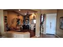 Warm foyer with decorative mirrors, vases, and a glimpse into the inviting living spaces at 18177 W Tasha Dr, Surprise, AZ 85388