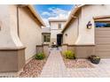 Elegant entryway with decorative pavers leading to a cozy seating area and the welcoming front door at 20256 E Canary Ct, Queen Creek, AZ 85142