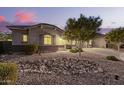 Inviting home with desert landscaping, showcasing its curb appeal and Southwest charm at 20256 E Canary Ct, Queen Creek, AZ 85142