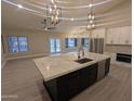 Open concept kitchen with quartz island and stainless steel appliances at 20677 N 16Th Way, Phoenix, AZ 85024