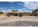 Inviting single-story brick home with a paved driveway, desert landscaping, and attached two car garage at 2222 E Gretta Pl, Phoenix, AZ 85022